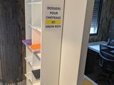 a white cabinet with a sign on it in a room