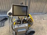a small cart that has a monitor on top of it