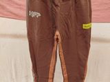 a pair of brown pants hanging on a clothes rack