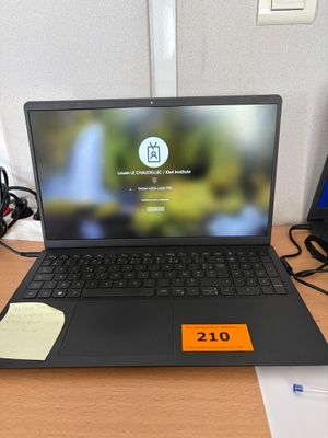 a laptop that is sitting on a desk with a price tag on it