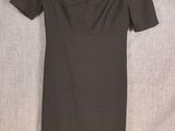 a black dress on a hanger on a white background