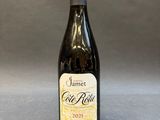an empty bottle of wine sitting on a table