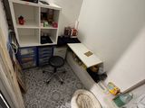 a small room with a bed and a desk in it