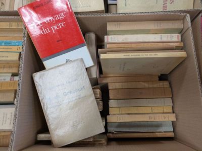 a box full of books that are stacked on top of each other