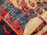 a close up of a rug with a tag on it