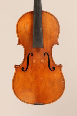 an old violin with a bow hanging from it ' s back