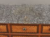 an old wooden chest of drawers with marble top