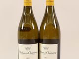 two bottles of wine sitting next to each other on a table