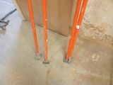 two orange poles that are on the floor in a room