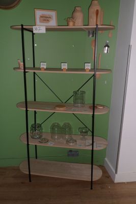 a display of skateboards on a green wall in a room