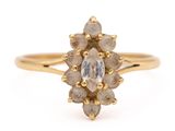 a close up of a gold ring with a white diamond