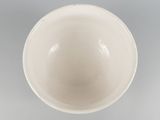 a white bowl sitting on top of a table