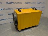 a yellow air conditioner sitting in front of a wall