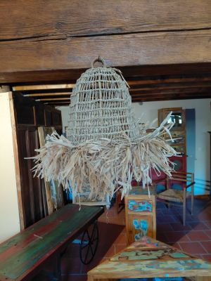 a wicker hanging from the ceiling in a room