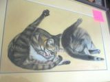 a picture of two cats that are laying down together