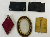 three pieces of jewelry are displayed on a white surface