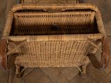 a wicker chair that is sitting on a tile floor