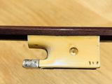 an image of a violin bow on a wooden table