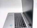 a silver laptop with a blue sticker on the screen