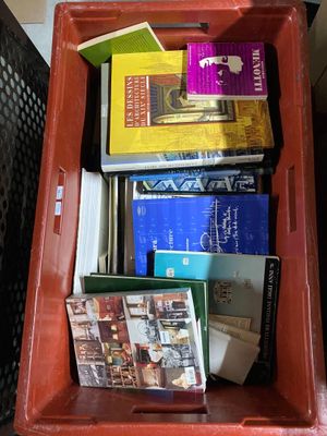 a red box filled with books on top of a table