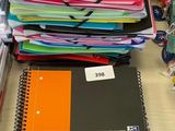 une pile de livres posée sur un bureau, à côté d'une autre pile de livres