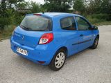 a small blue car parked in a parking lot