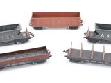 four different types of train cars on a white surface