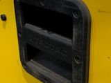 a yellow vending machine with a black handle
