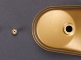 a gold sink with a metal faucet next to it