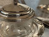 a silver plate with a glass lid on a table