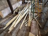 many pieces of wood sitting on the floor in a building