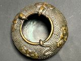 an image of a gold plate with a fish design on it