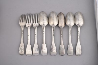 six spoons and a fork are lined up in a row
