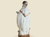 a statue of a man holding a knife and a book