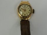 an image of a gold wrist watch with a brown leather strap