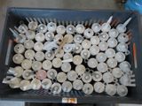 a basket full of white and gray cups and spoons