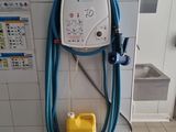 a blue hose attached to a wall next to a yellow can