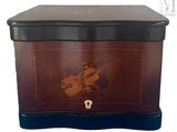 an image of a wooden box with a violin design on it