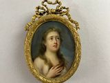 portrait of a young woman in a gold frame with a crown