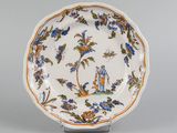 an image of a plate with a bird and flowers on it