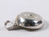 a silver object that is sitting on a white surface