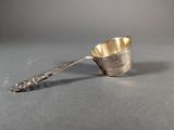 a close up of a spoon with a handle on a table
