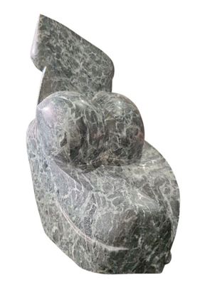 a marble chair that is sitting on a white surface