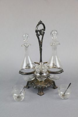 un plateau en argent sur lequel sont posées quatre carafes en verre
