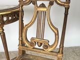 a small table and a chair with a marble top