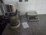 une photo d'un plan de travail de cuisine sur lequel se trouvent un mixeur et une balance