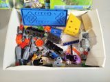 a box full of legos and other toys on a table