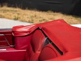 a red convertible car with a red seat and back seat