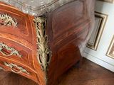 a marble top chest of drawers in a room
