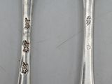 two spoons sitting next to each other on a table